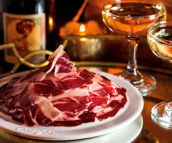Conco Jotas Jamon Iberico with champagne in background
