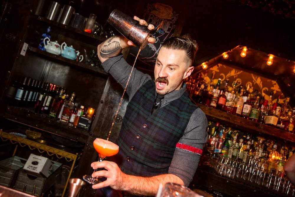 bartenders working behind the bar